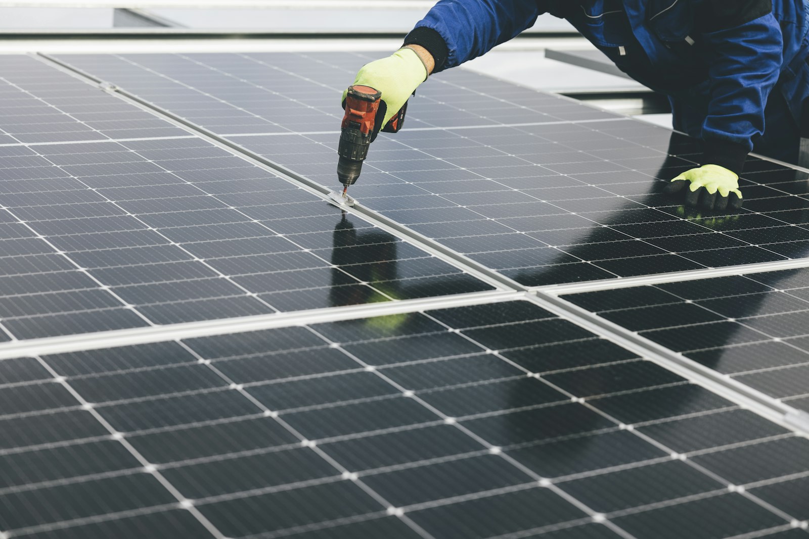 A Green Way Solar engineer fixing panel rails on a flat commercial roof.
